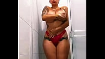 Beautiful and voluptuous busty woman touches herself provocatively in the shower